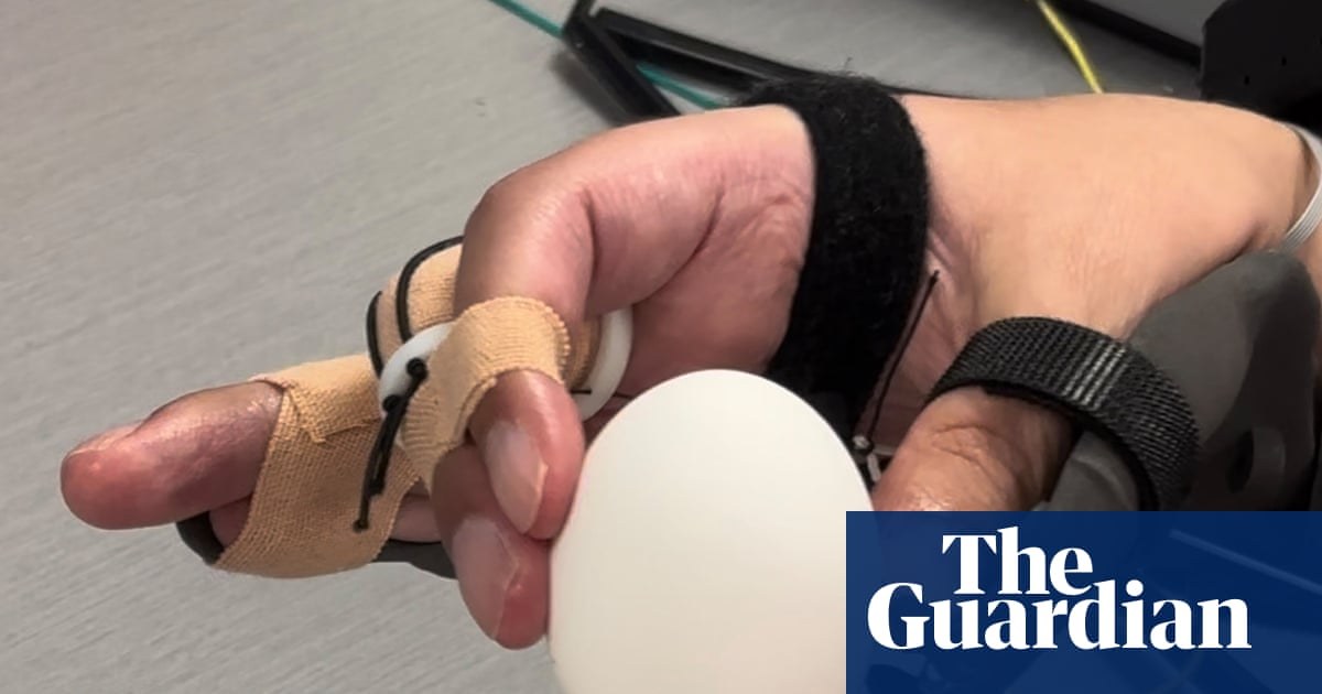 Brain implant helps paralysed man to feed himself and drink from cup